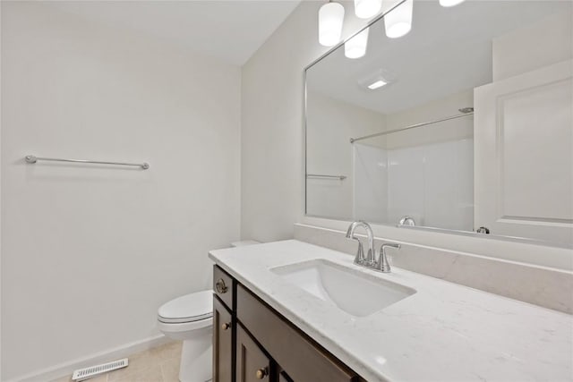 bathroom with visible vents, toilet, baseboards, walk in shower, and vanity