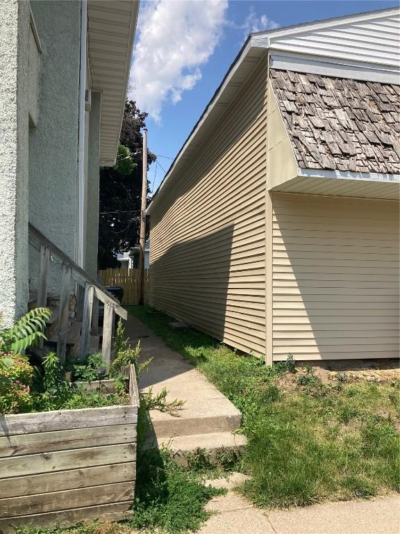 view of home's exterior with fence