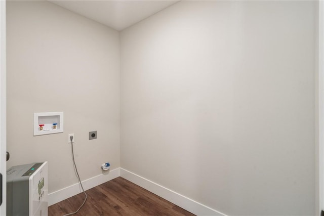 clothes washing area with dark wood-style floors, baseboards, hookup for an electric dryer, laundry area, and washer hookup