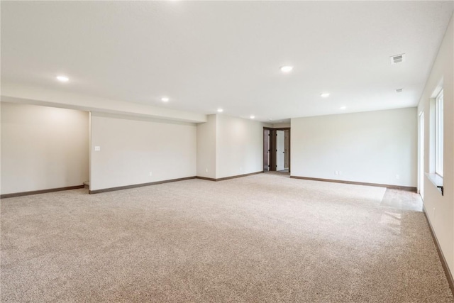 spare room with light carpet, visible vents, and recessed lighting