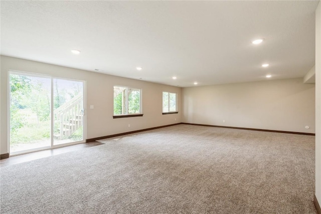 carpeted empty room featuring recessed lighting and baseboards