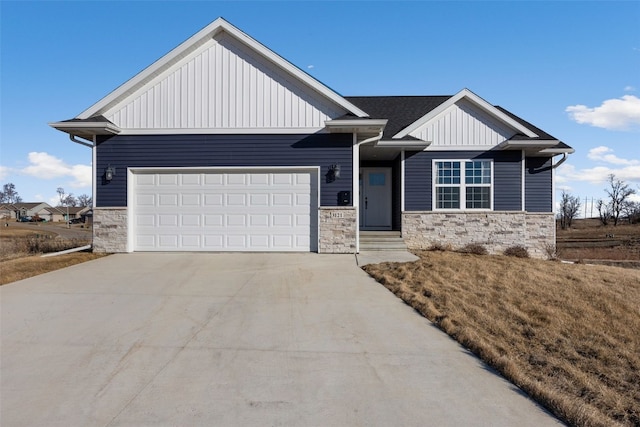 view of front of property with stone siding, board and batten siding, an attached garage, and driveway