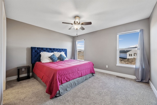 bedroom with carpet, visible vents, baseboards, and a ceiling fan