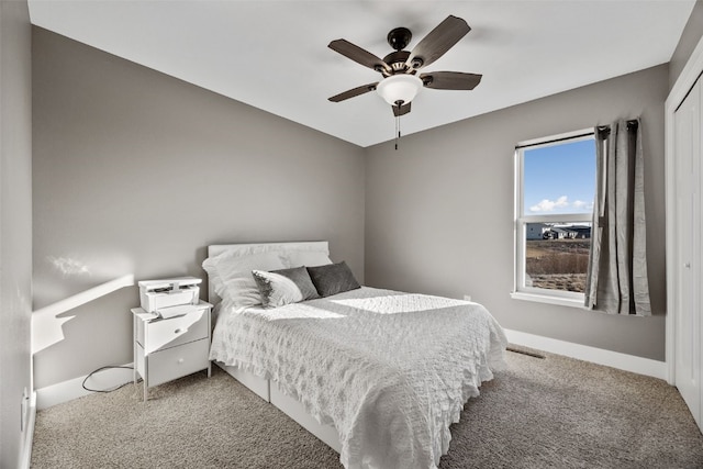 carpeted bedroom featuring a ceiling fan and baseboards