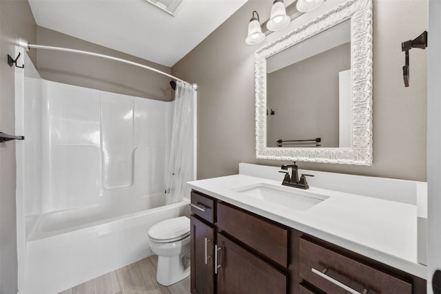 bathroom featuring vanity, toilet, wood finished floors, and shower / tub combo