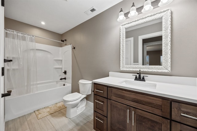 bathroom with visible vents, toilet, vanity, and shower / tub combo with curtain