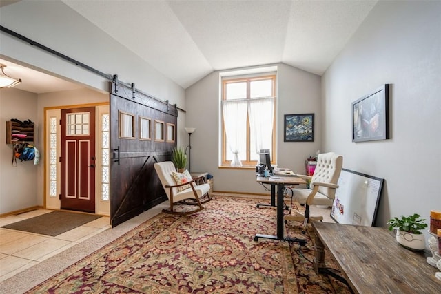 office area featuring tile patterned floors, baseboards, a barn door, and vaulted ceiling