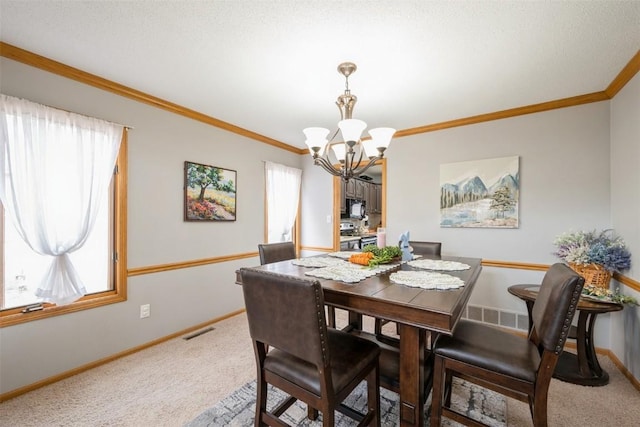 dining room with visible vents, a healthy amount of sunlight, and carpet