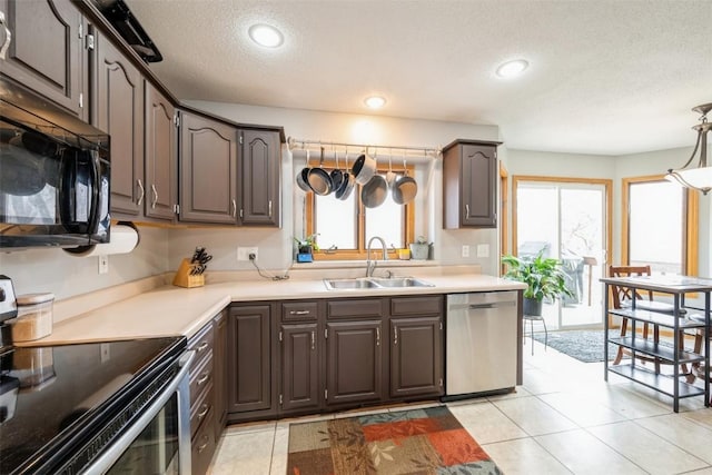 kitchen with a sink, stainless steel appliances, a healthy amount of sunlight, and recessed lighting