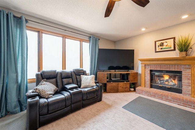 carpeted living area with recessed lighting, a ceiling fan, a healthy amount of sunlight, and a fireplace