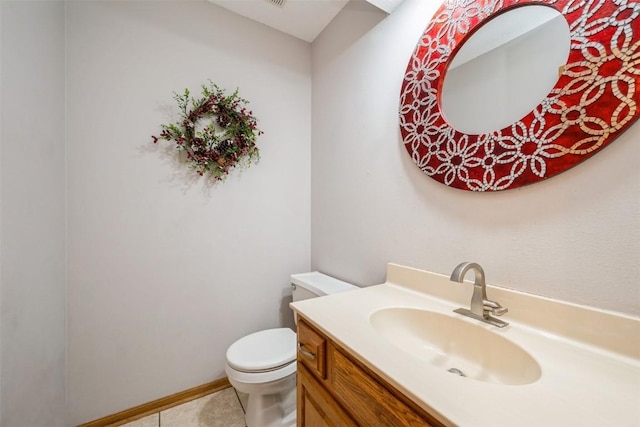 bathroom with tile patterned flooring, toilet, vanity, and baseboards