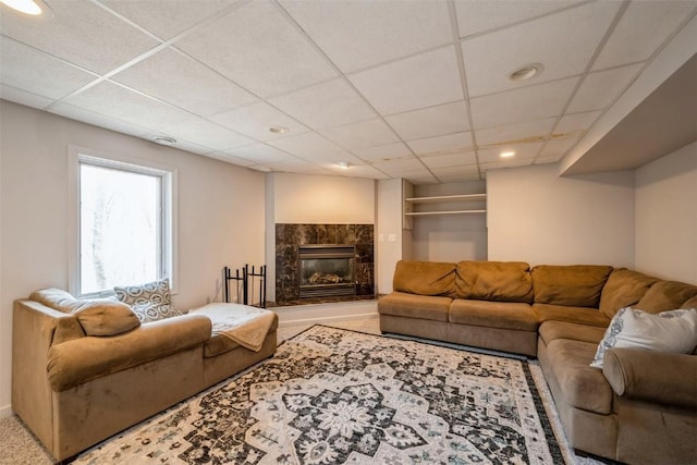 living room with carpet, recessed lighting, a fireplace, and a drop ceiling