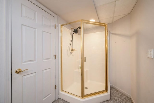 bathroom with baseboards and a shower stall