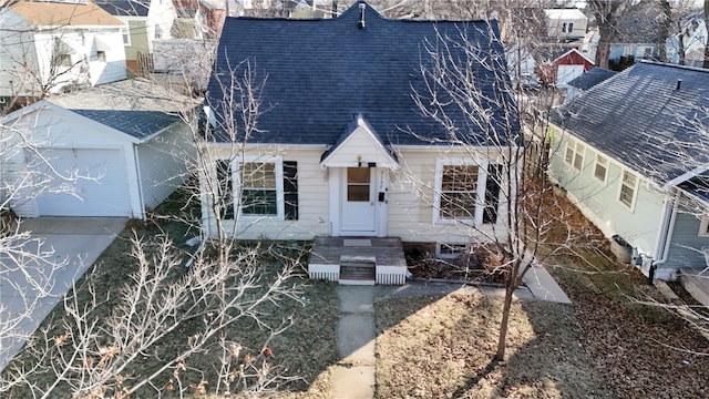 view of front of property with a garage and roof with shingles