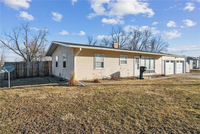 ranch-style home with a front lawn, fence, a chimney, a garage, and driveway