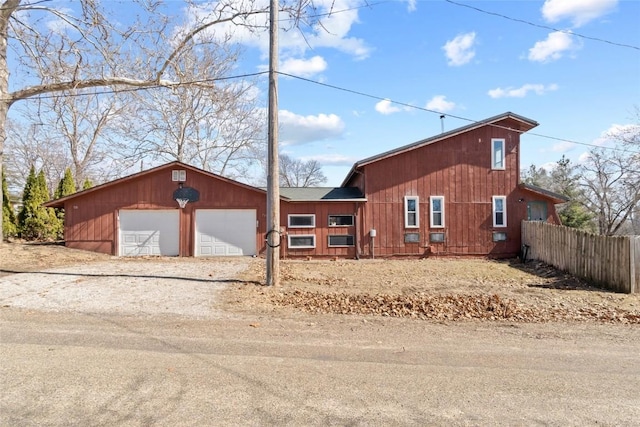 chalet / cabin with fence and dirt driveway