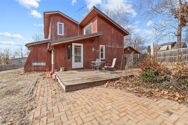 rear view of property featuring fence