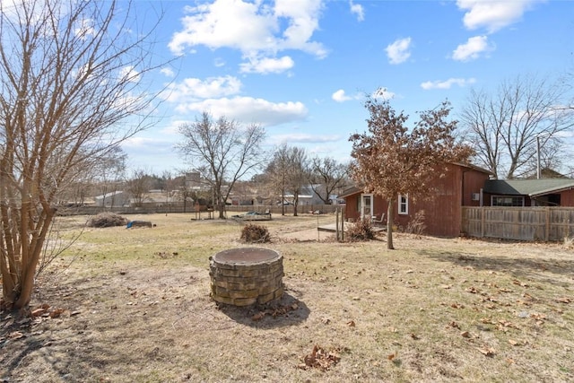 view of yard featuring fence and an outdoor fire pit