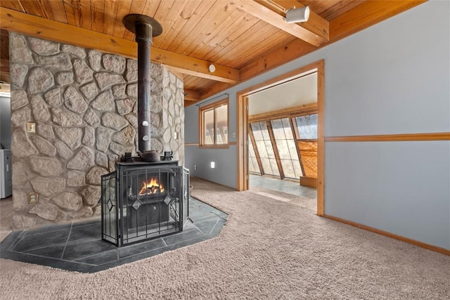 room details featuring beamed ceiling, carpet floors, wood ceiling, and a wood stove