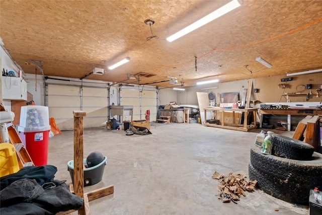 garage with a workshop area and a garage door opener