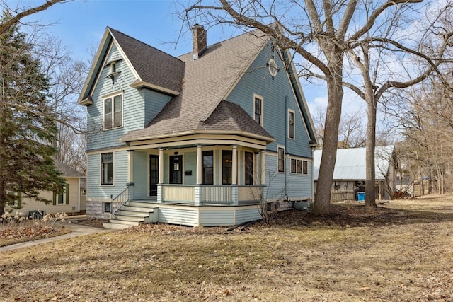 view of front of property featuring roof with shingles, covered porch, and a chimney