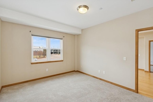 empty room with carpet flooring and baseboards