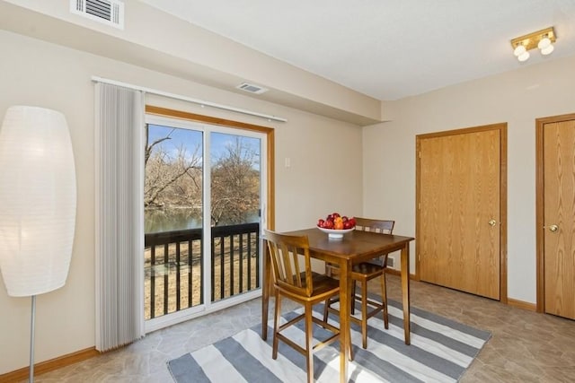 dining space featuring visible vents and baseboards