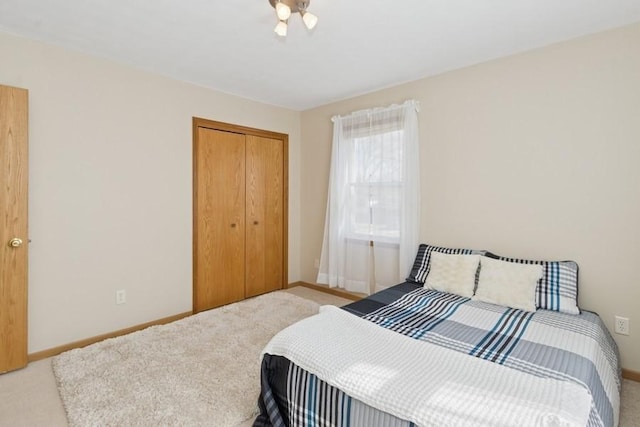 bedroom featuring a closet, carpet flooring, and baseboards