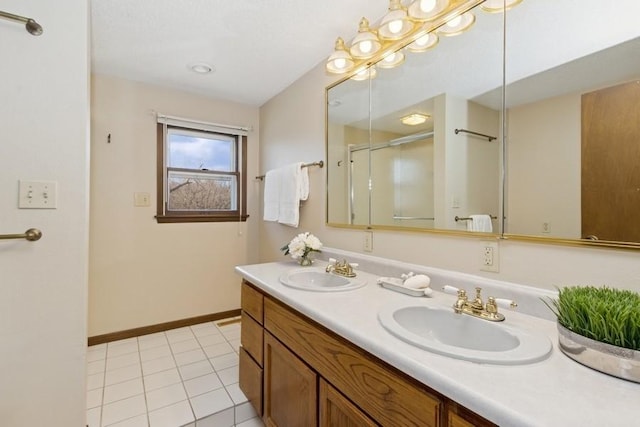 full bathroom featuring tile patterned flooring, double vanity, baseboards, and a sink