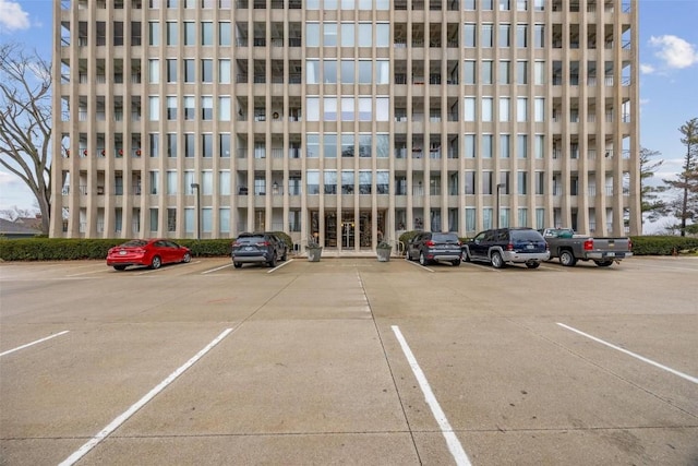 view of building exterior with uncovered parking