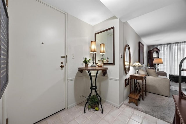 entryway featuring light tile patterned floors and baseboards