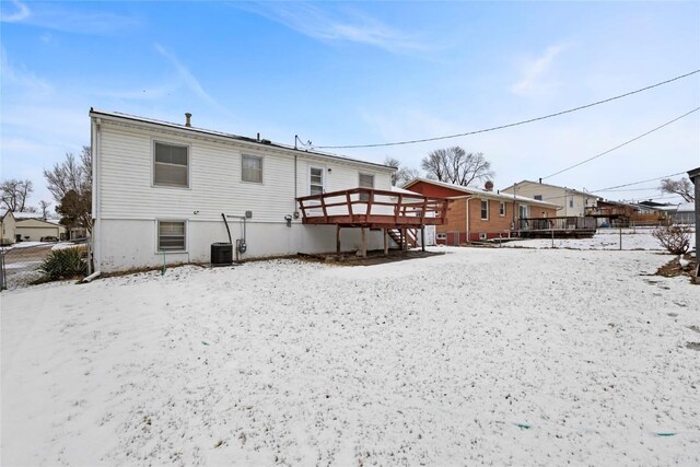 snow covered property featuring a wooden deck