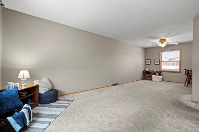 living area featuring carpet flooring, visible vents, and baseboards