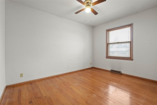 unfurnished room with visible vents, ceiling fan, light wood-type flooring, and baseboards