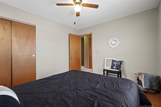 bedroom with a closet, wood finished floors, and a ceiling fan