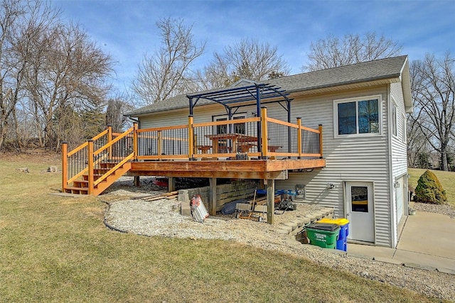 back of property with a deck, a lawn, and a shingled roof