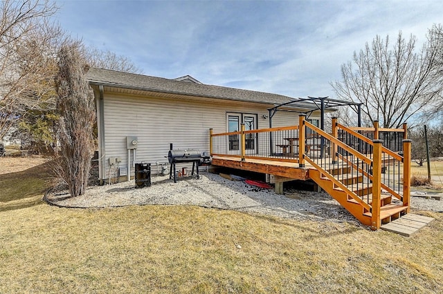 back of property featuring a deck and a yard