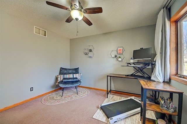 sitting room featuring carpet flooring, baseboards, visible vents, and a textured ceiling