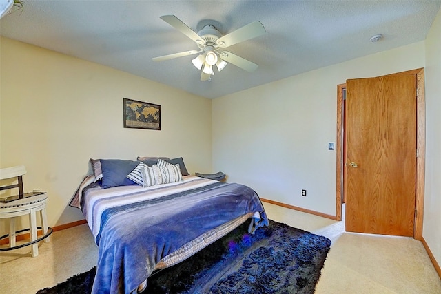 bedroom featuring carpet flooring, a ceiling fan, and baseboards