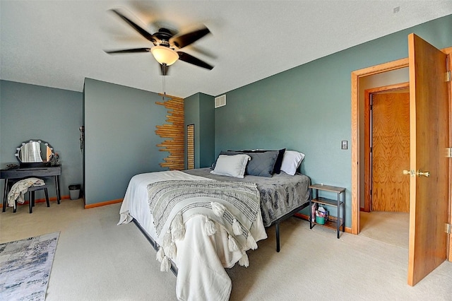 carpeted bedroom featuring visible vents, baseboards, and a ceiling fan