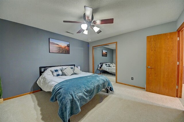 bedroom with visible vents, baseboards, carpet, and a closet