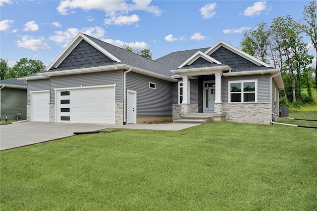 craftsman inspired home featuring stone siding, concrete driveway, a garage, and a front yard