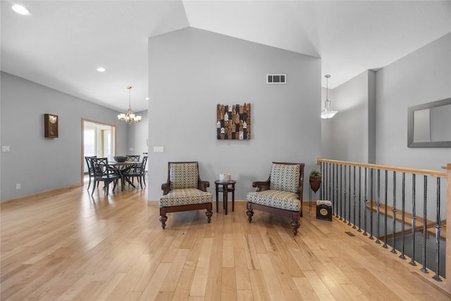 living area with a notable chandelier, visible vents, recessed lighting, and light wood-type flooring