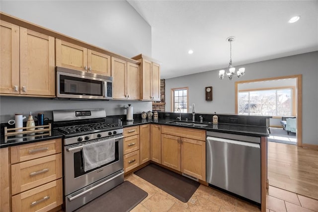 kitchen featuring light brown cabinets, a peninsula, recessed lighting, a sink, and stainless steel appliances