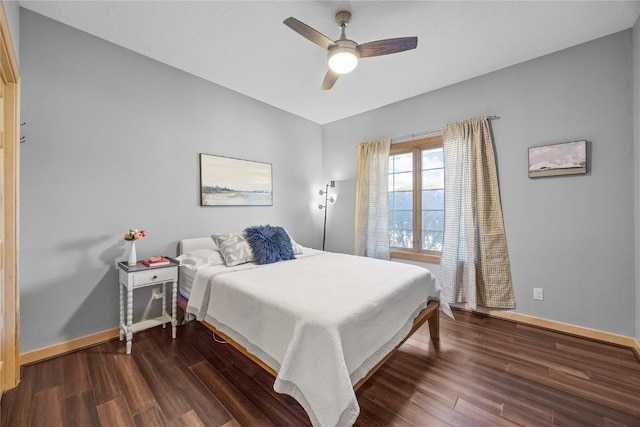 bedroom featuring baseboards, ceiling fan, and dark wood-style flooring