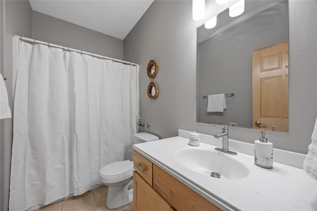 bathroom with tile patterned floors, curtained shower, toilet, and vanity