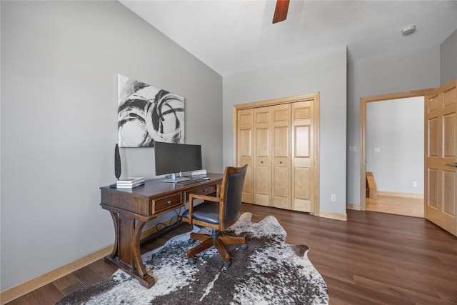 home office featuring baseboards, wood finished floors, a ceiling fan, and vaulted ceiling