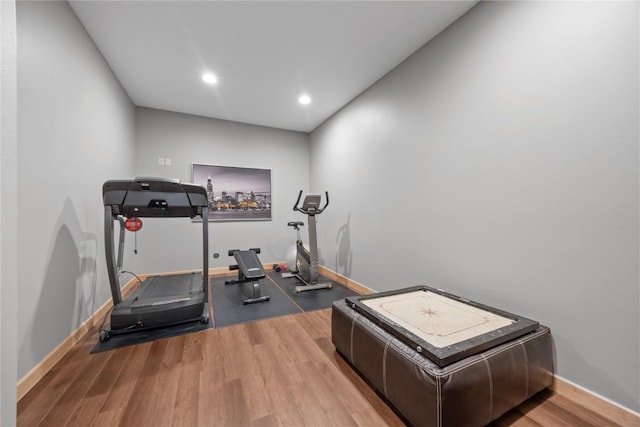 exercise area featuring recessed lighting, baseboards, and wood finished floors