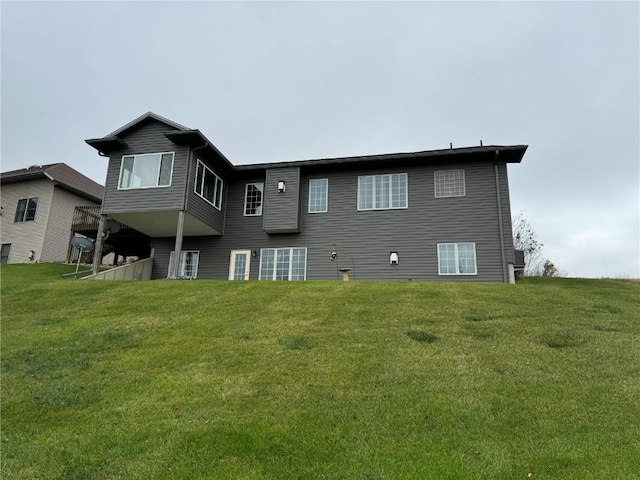 back of house with a lawn