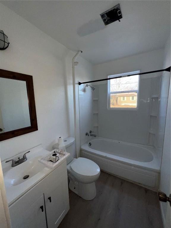 full bathroom featuring vanity, toilet, wood finished floors, and shower / bathtub combination